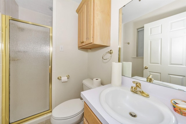 bathroom featuring vanity, toilet, and a shower stall