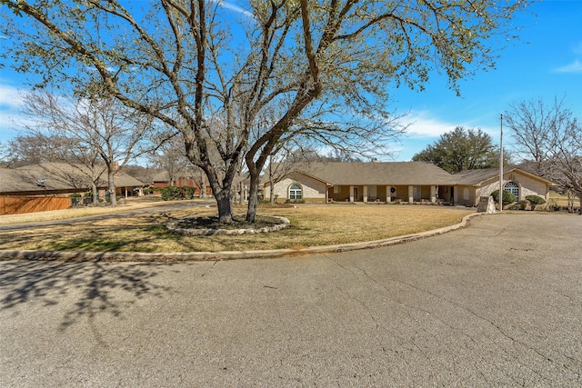 view of front of home with aphalt driveway and a front yard