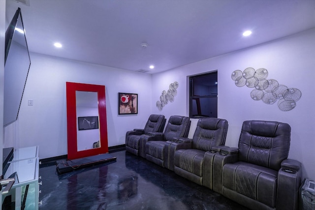 cinema room featuring finished concrete floors, recessed lighting, visible vents, and baseboards