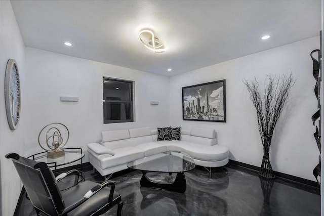 living area featuring recessed lighting, baseboards, and finished concrete flooring