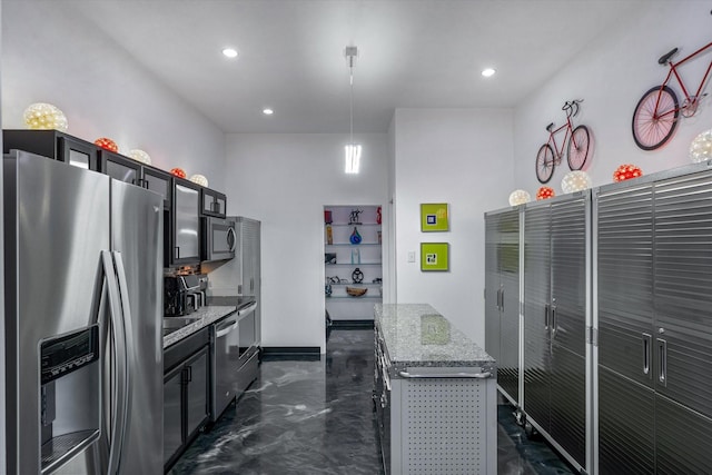 kitchen featuring dark cabinetry, light stone counters, a kitchen island, recessed lighting, and stainless steel appliances