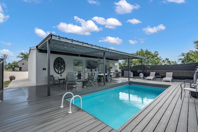 view of pool with a wooden deck, a fenced in pool, and fence