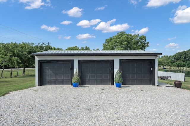 detached garage featuring fence