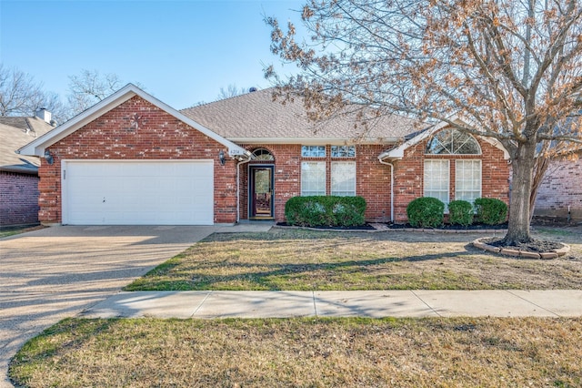 ranch-style house featuring a front yard, driveway, roof with shingles, a garage, and brick siding