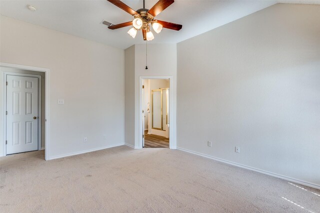 unfurnished room featuring visible vents, light colored carpet, baseboards, and vaulted ceiling