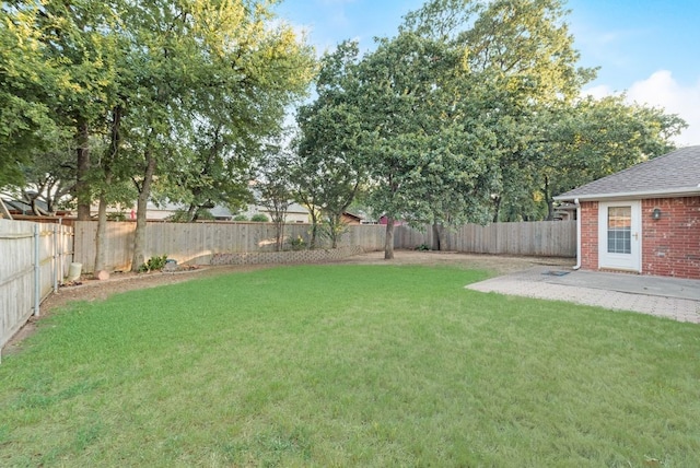 view of yard featuring a patio and a fenced backyard