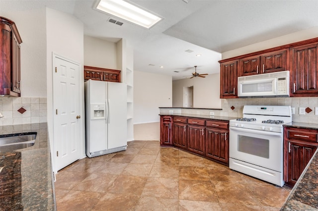 kitchen with a sink, white appliances, tasteful backsplash, and dark brown cabinets