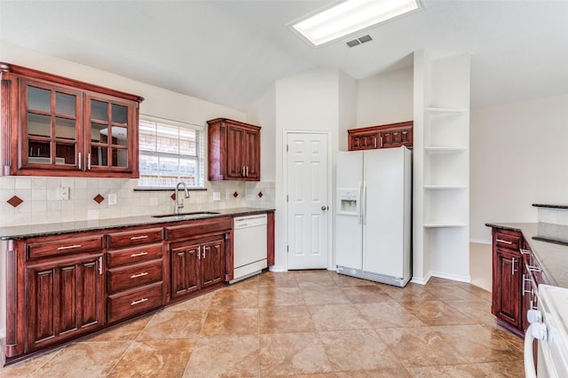 kitchen with a sink, decorative backsplash, white appliances, and dark brown cabinets