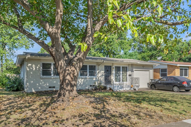 ranch-style home featuring a garage, brick siding, and crawl space