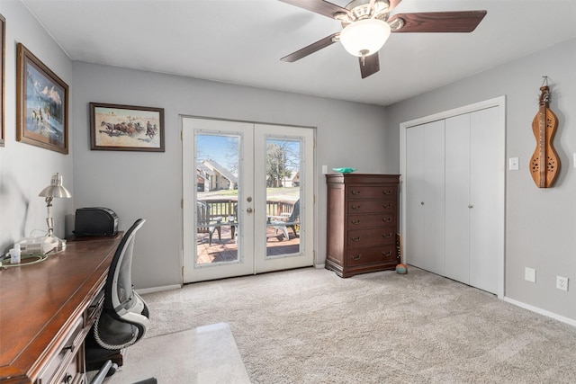 carpeted office space with french doors, baseboards, and ceiling fan