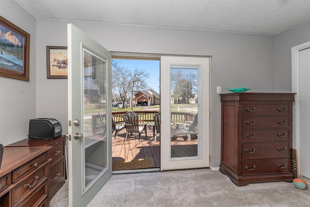 entryway with french doors and light carpet