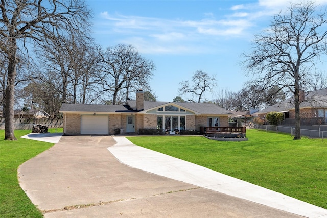 mid-century home featuring brick siding, a front lawn, fence, a chimney, and an attached garage