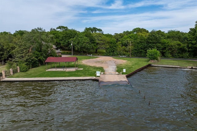 exterior space featuring a water view and a lawn