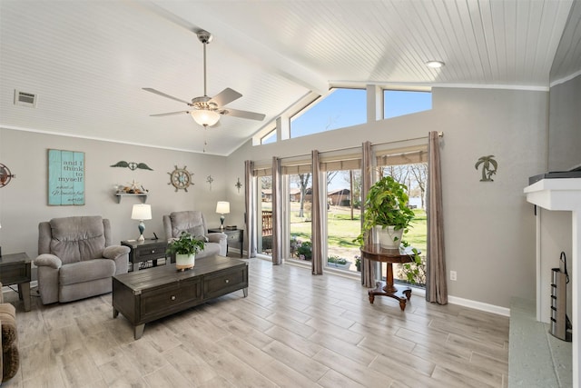 living room featuring visible vents, baseboards, lofted ceiling with beams, light wood-style flooring, and a fireplace