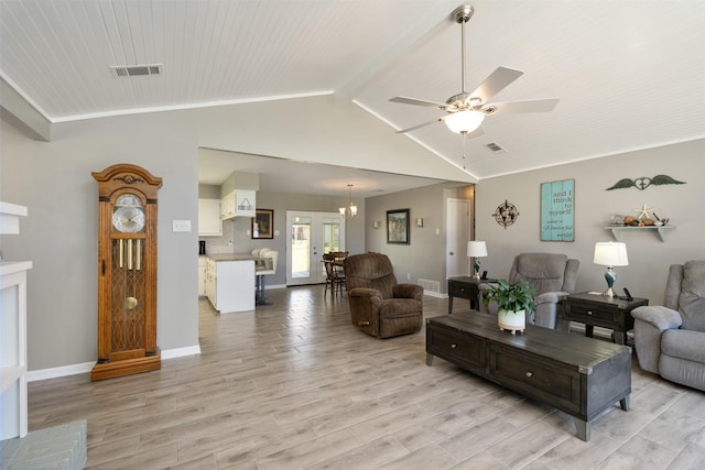 living area featuring visible vents, light wood-style flooring, baseboards, and vaulted ceiling