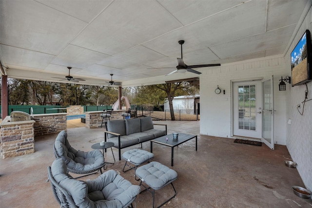 view of patio featuring a ceiling fan, a fenced backyard, and outdoor lounge area