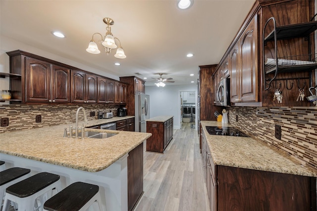 kitchen with light wood-type flooring, open shelves, a sink, stainless steel appliances, and dark brown cabinetry