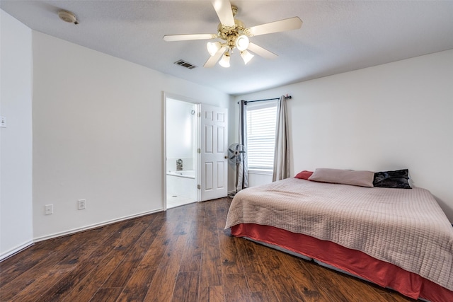 bedroom with connected bathroom, visible vents, wood finished floors, and a ceiling fan