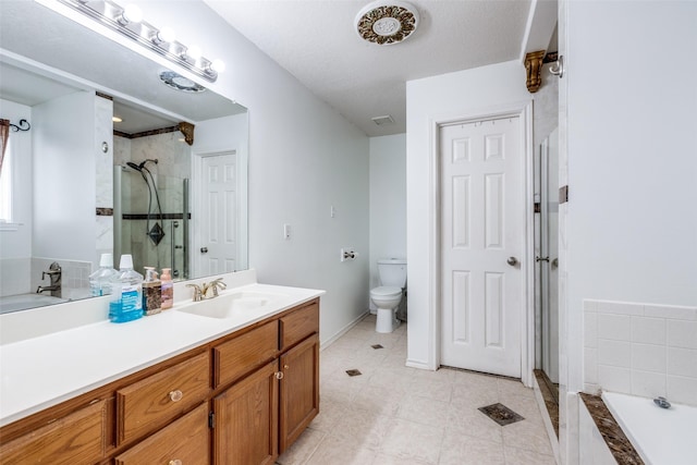 full bathroom featuring a shower stall, toilet, a garden tub, tile patterned floors, and vanity