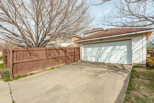 detached garage featuring fence