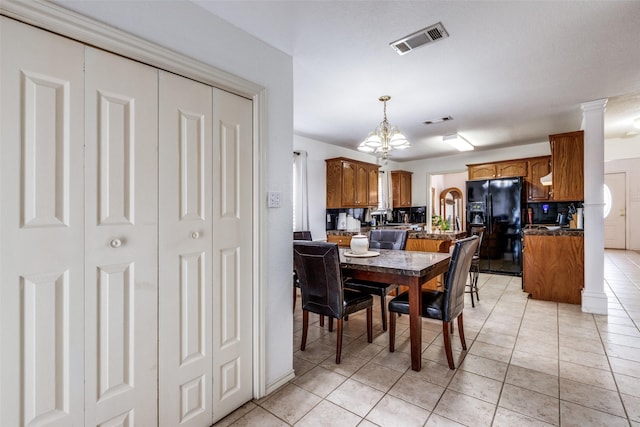 dining space featuring light tile patterned floors and visible vents