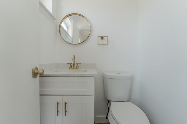 bathroom with toilet and vanity