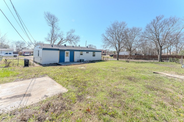 back of property featuring a patio area, fence, and a lawn