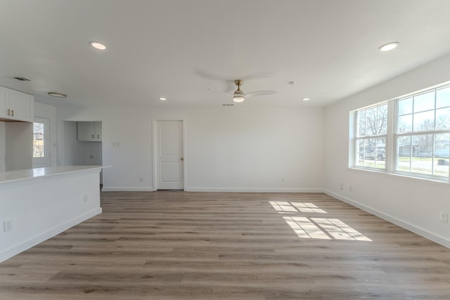 spare room with recessed lighting, baseboards, light wood-style floors, and a ceiling fan