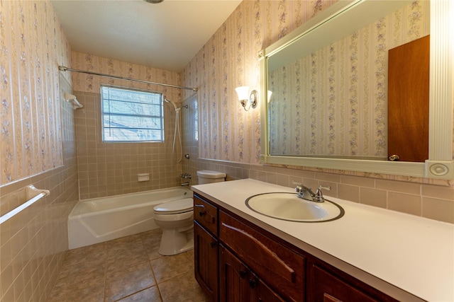 bathroom featuring toilet, tile walls, shower / bathtub combination, and wallpapered walls