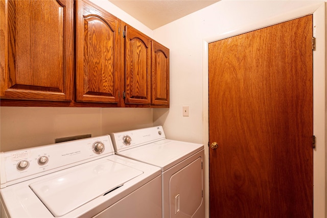 laundry room with cabinet space and separate washer and dryer