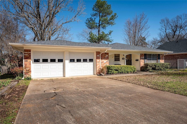 single story home with fence, driveway, a shingled roof, a garage, and brick siding