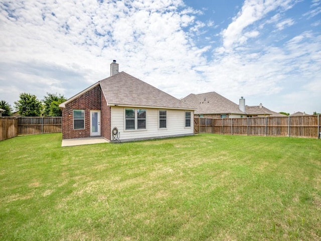 231 Archer Way, Forney, TX 75126 - back of property with brick siding, a lawn, a chimney, a fenced backyard, and a patio