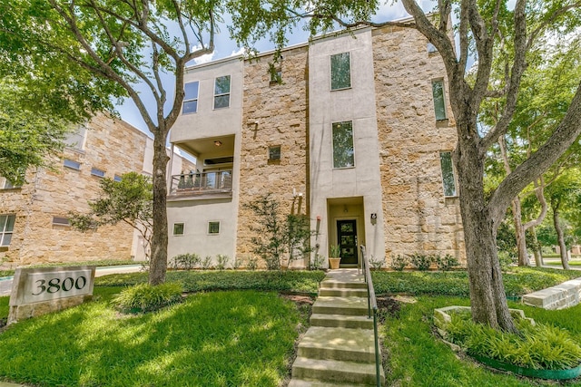 view of front of home with stone siding and stucco siding