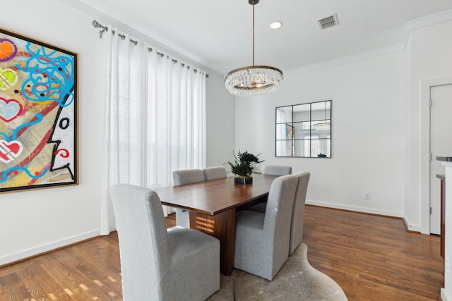 dining area with visible vents, ornamental molding, baseboards, and wood finished floors