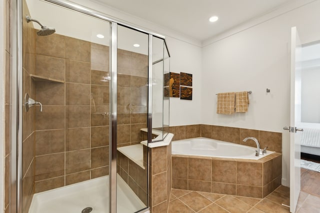 ensuite bathroom featuring a shower stall, a garden tub, and tile patterned floors