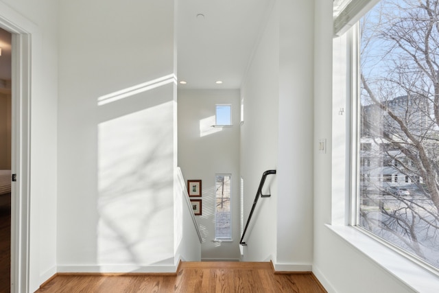 entrance foyer featuring a high ceiling, recessed lighting, wood finished floors, and baseboards