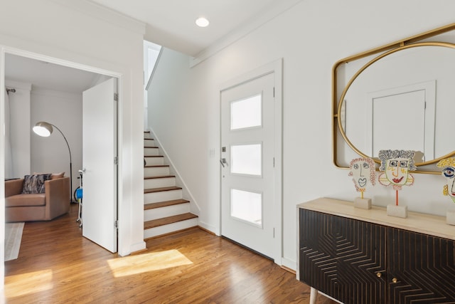 entryway featuring a wealth of natural light, recessed lighting, stairs, and light wood-style floors