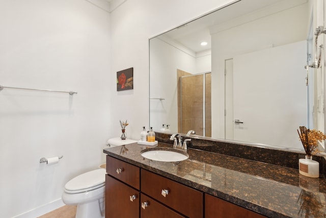 bathroom with toilet, vanity, and a tile shower