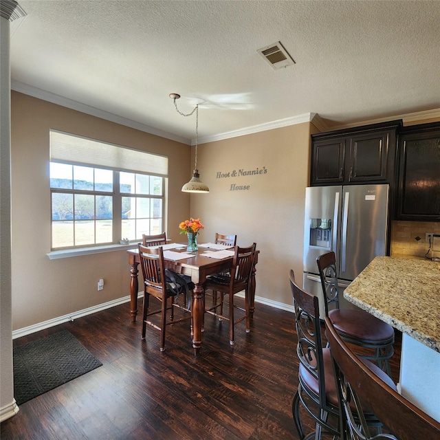 dining room featuring visible vents, dark wood-type flooring, and ornamental molding