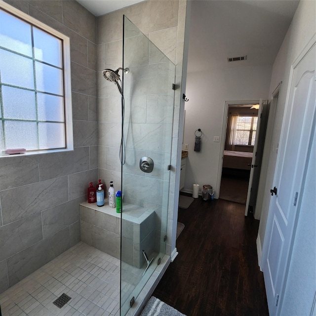 full bath featuring visible vents, toilet, wood finished floors, and a stall shower