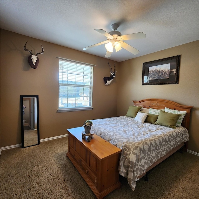 carpeted bedroom featuring a ceiling fan, baseboards, and a textured ceiling