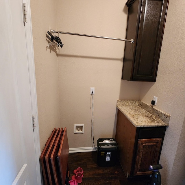 laundry room featuring cabinet space, radiator, hookup for a washing machine, and dark wood-type flooring