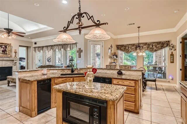 kitchen with a large island, visible vents, crown molding, and black microwave