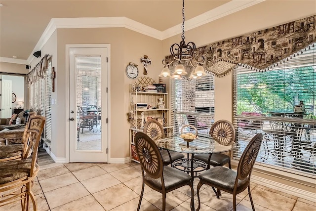 dining room with an inviting chandelier, crown molding, baseboards, and tile patterned floors