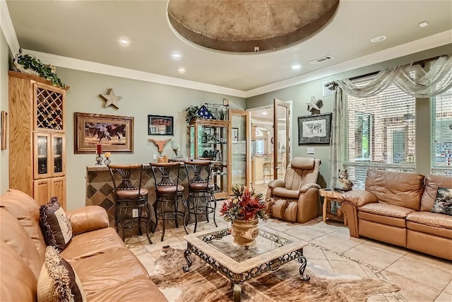 living room featuring a dry bar, recessed lighting, visible vents, and ornamental molding