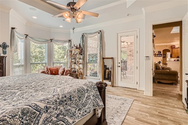 bedroom featuring ceiling fan, light wood-type flooring, ornamental molding, arched walkways, and access to outside