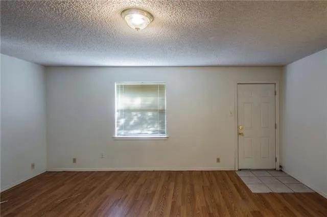 6743 Westcreek Dr, Fort Worth, TX 76133 - entrance foyer with a textured ceiling and wood finished floors