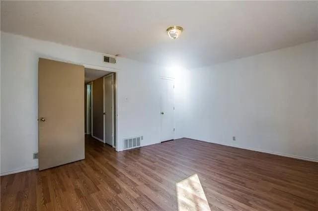 6743 Westcreek Dr, Fort Worth, TX 76133 - spare room with visible vents and wood finished floors