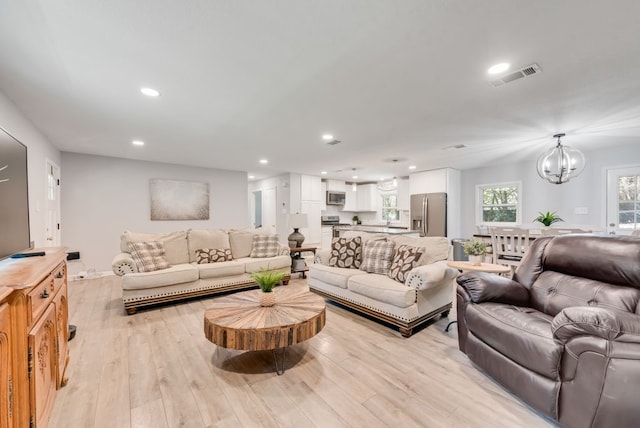 living area featuring light wood-type flooring, visible vents, a chandelier, and recessed lighting