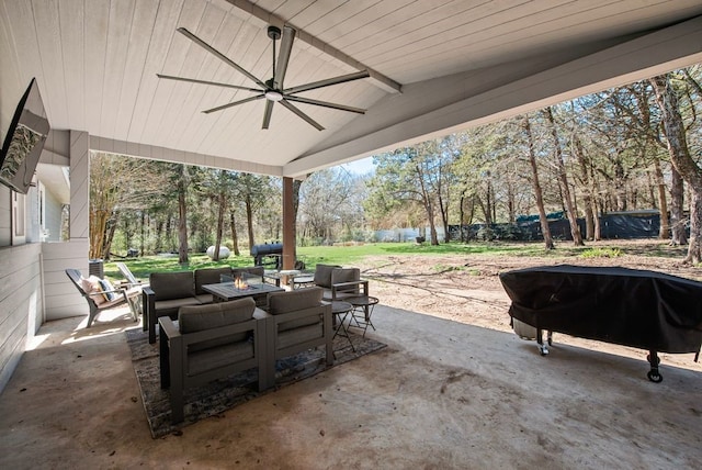 view of patio / terrace with an outdoor living space with a fire pit and a ceiling fan